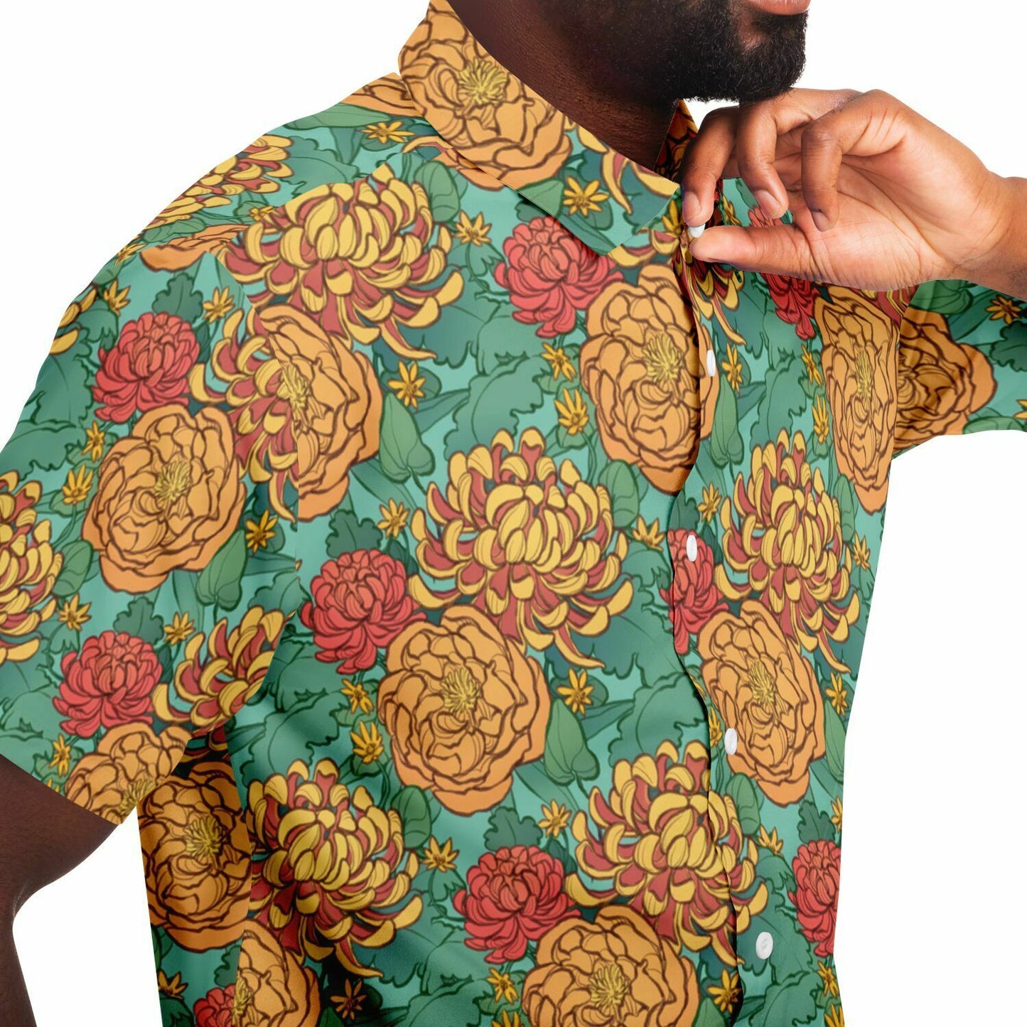 A model wearing a button down. The button down's pattern features yellow and red chrysanthemums, and orange peonies on a green background.