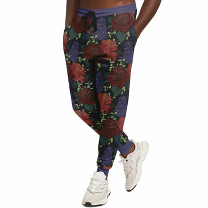 A thin black man modeling the pair of joggers. His hands are in his pockets.