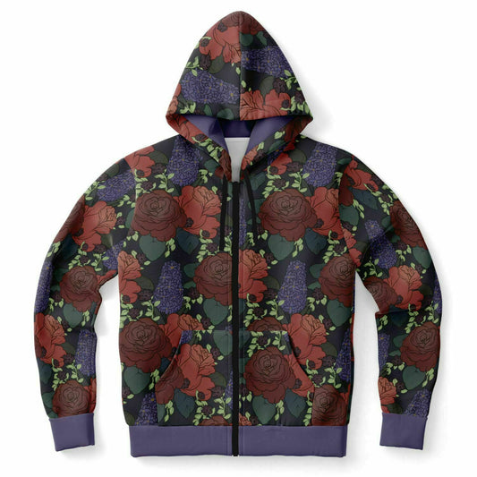 A flat lying hoodie. The hoodie's pattern features red roses, purple hyacinths, and small black flowers on a dark grey background. It has a purple hem and cuffs