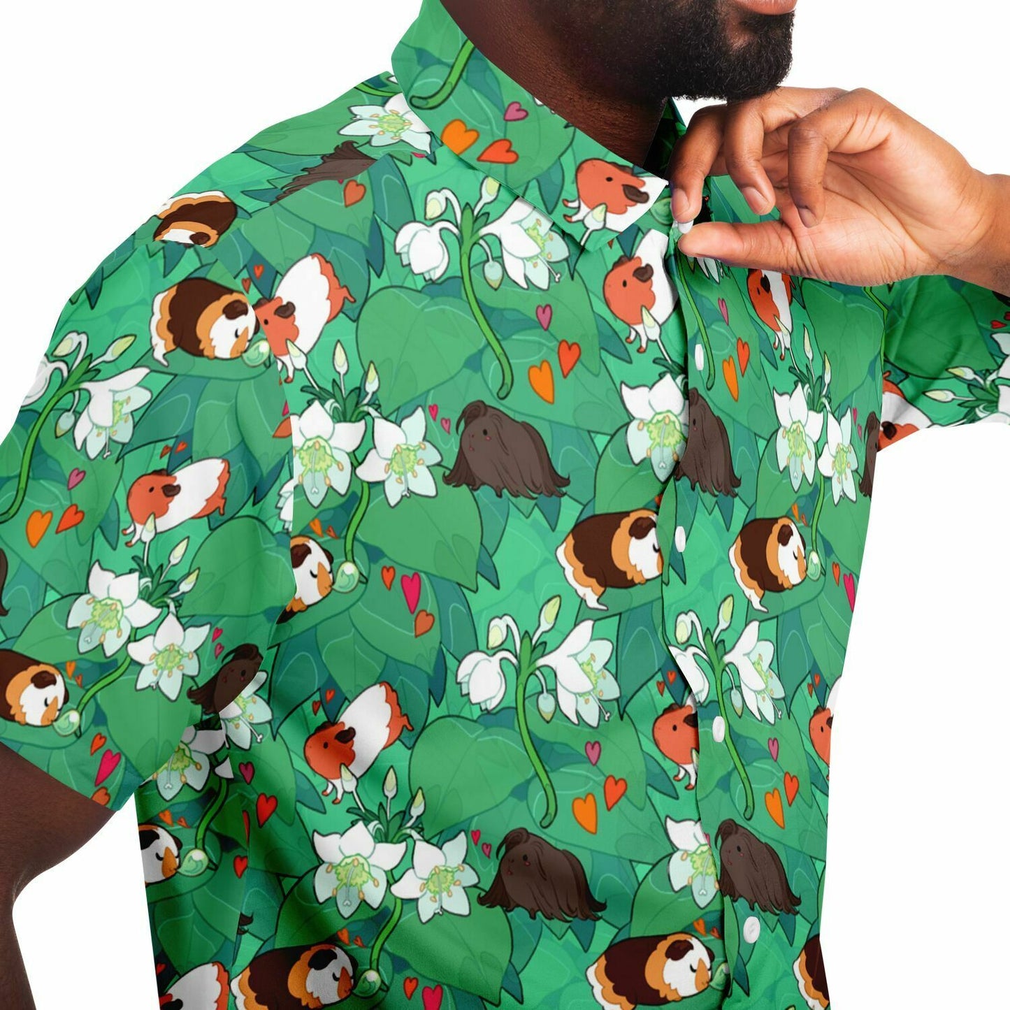 A model wearing a button down. The button down's pattern features guinea pigs and delphinium flowers on a green leafy background.