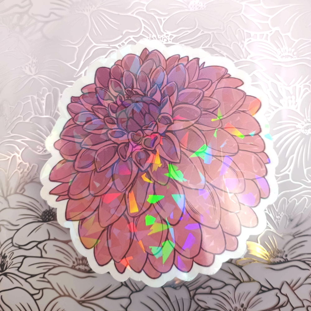 A sticker of a dark red Dahlia with holo shards.