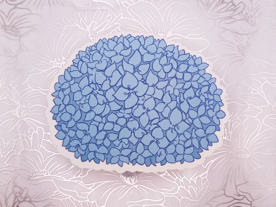 A matte sticker of a blue Hydrangea.