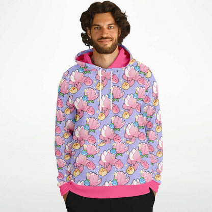 A model wearing a hoodie. The hoodie's pattern features cute round birds and magnolia on a purple background. The trims are pink. 