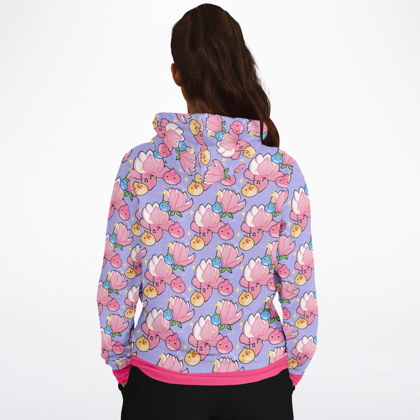 A model wearing a hoodie. The hoodie's pattern features cute round birds and magnolia on a purple background. The trims are pink. 