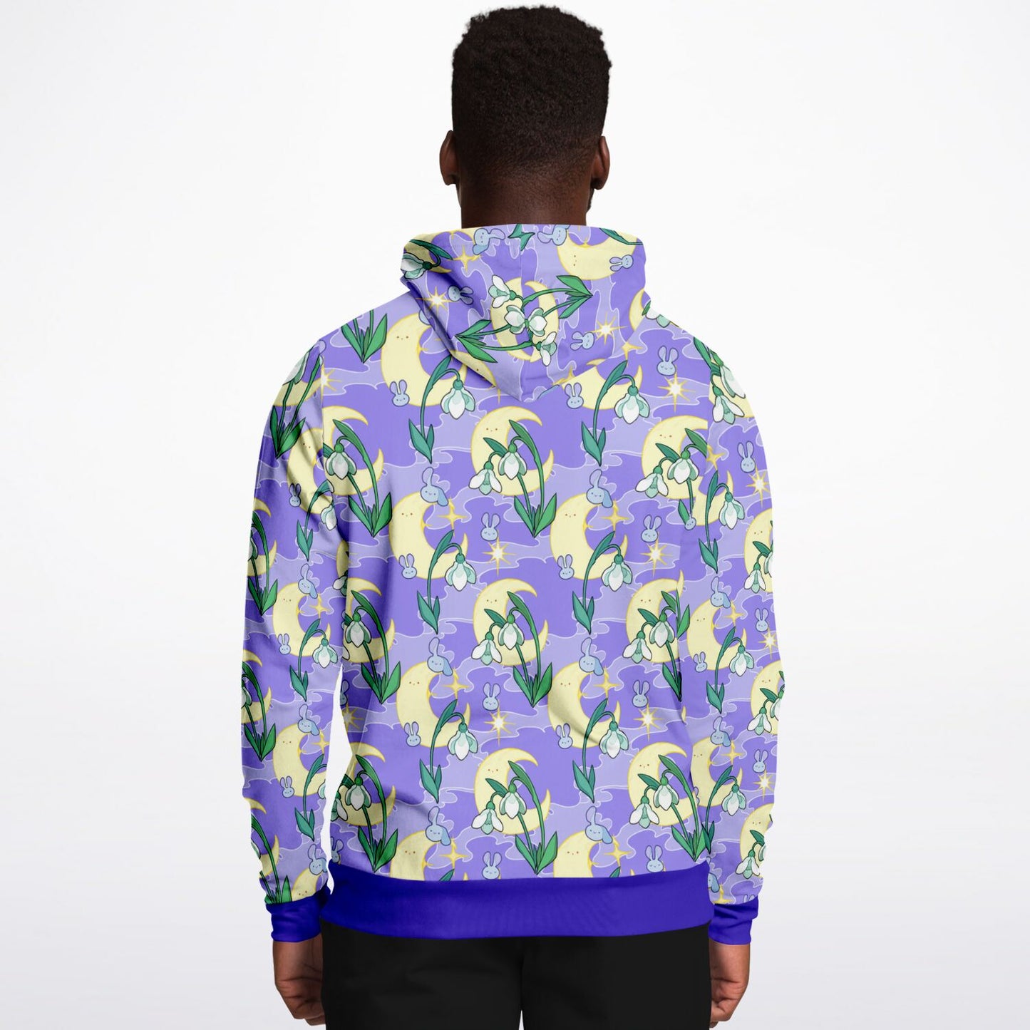 A model wearing a hoodie. The hoodie's pattern features bunnies, snowbells, and the moon. It has a purple smokey background.