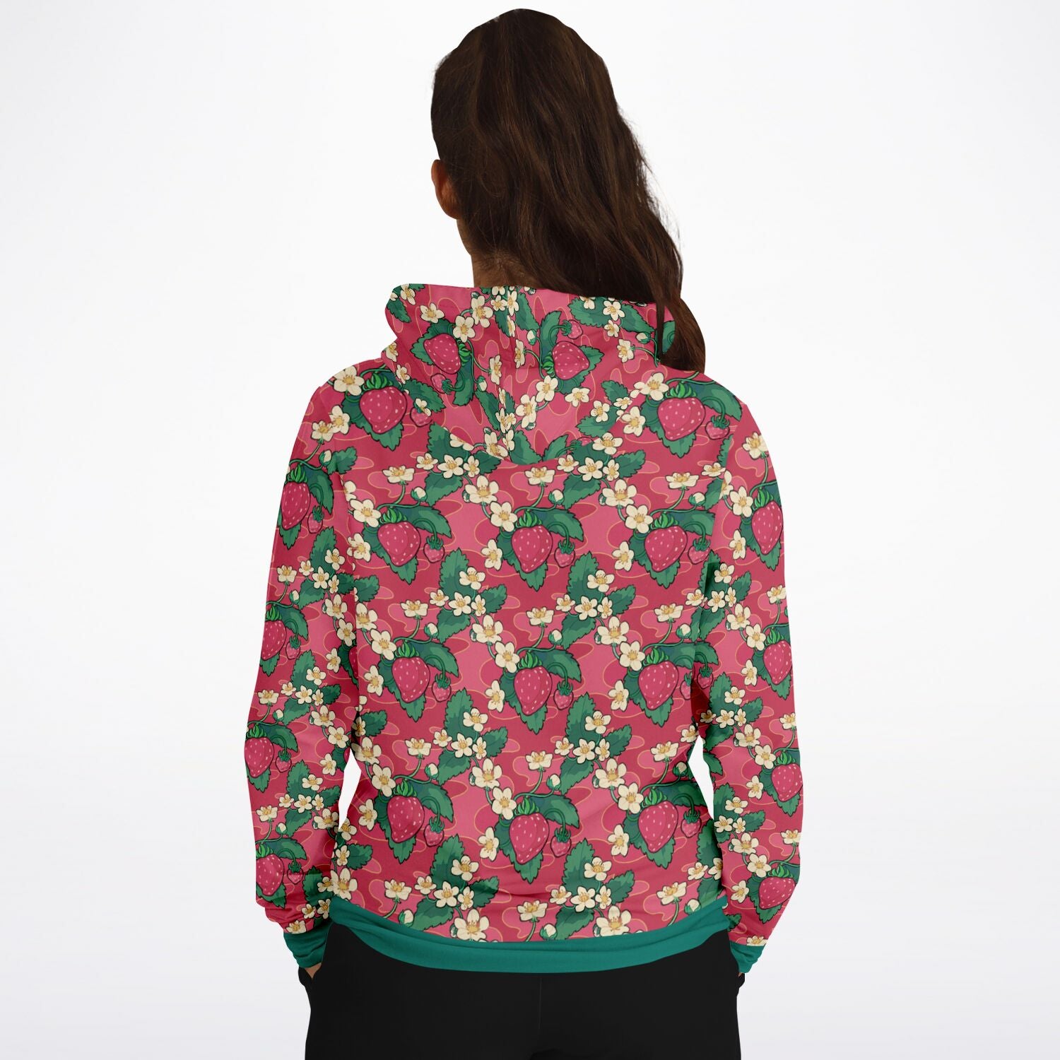 A model wearing a hoodie. The hoodie's pattern features strawberries and strawberry blossoms. The trims and lining of the hoodie are green. 