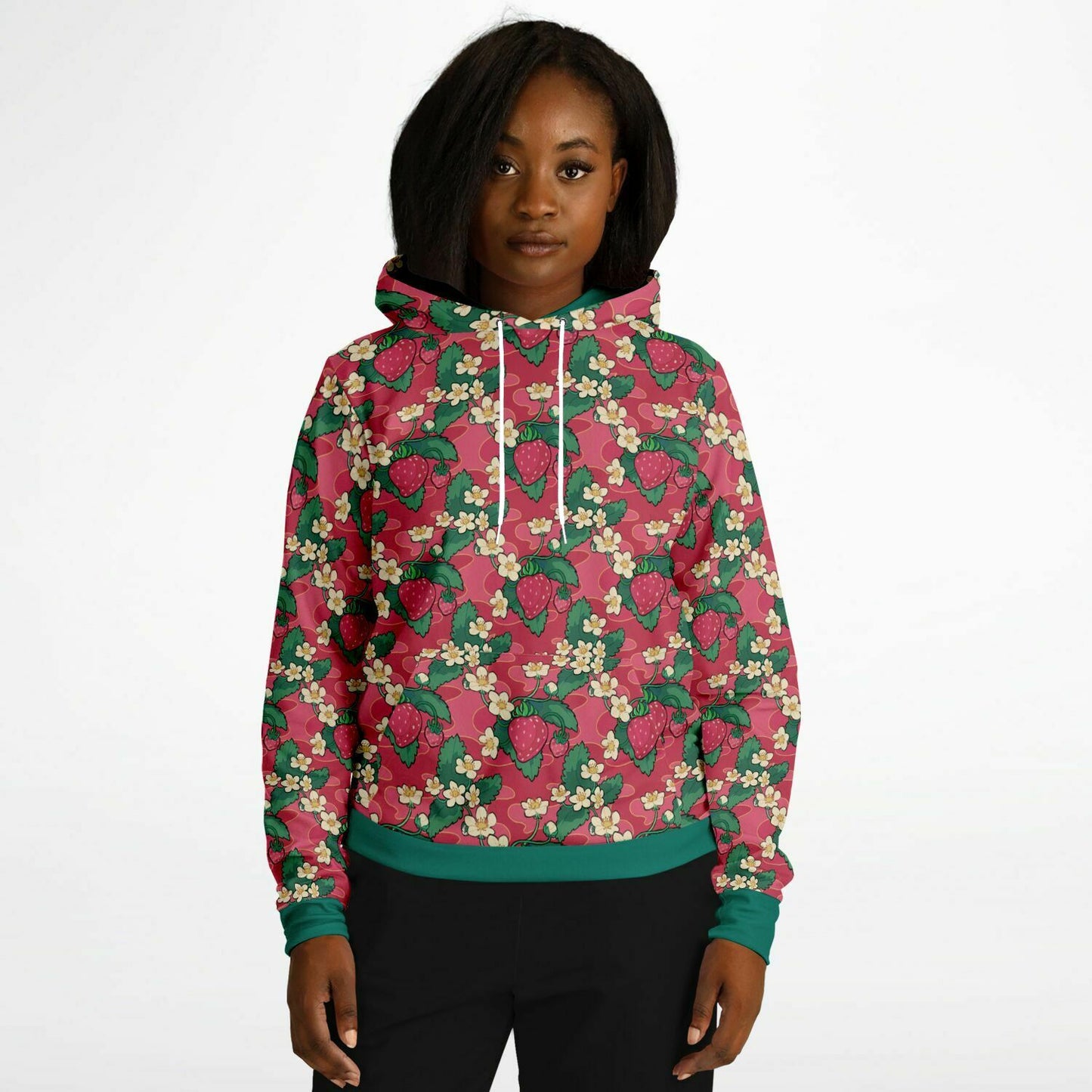 A model wearing a hoodie. The hoodie's pattern features strawberries and strawberry blossoms. The trims and lining of the hoodie are green. 