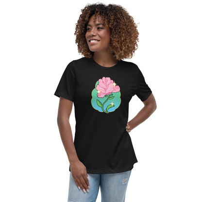 A model wearing a black tshirt. It has a print of a pink rose flower on the front.