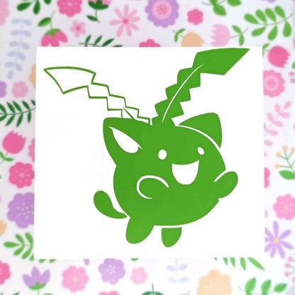 Green vinyl sticker of a hoppip. It's floating with a happy expression