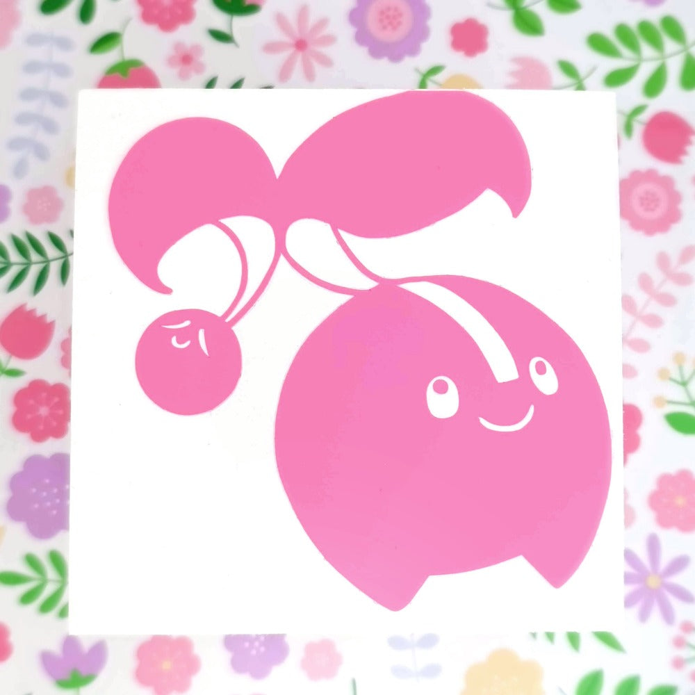 Pink vinyl sticker of an cherubi. It's standing with a content expression.